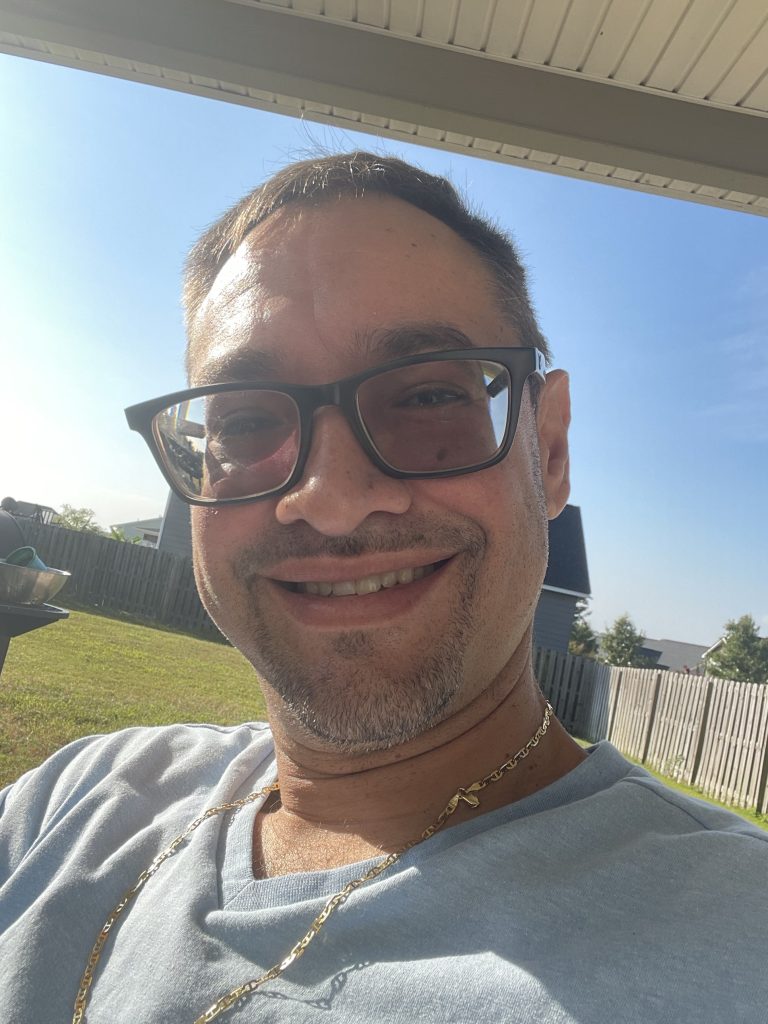 Hector Guerrero outdoors wearing glasses